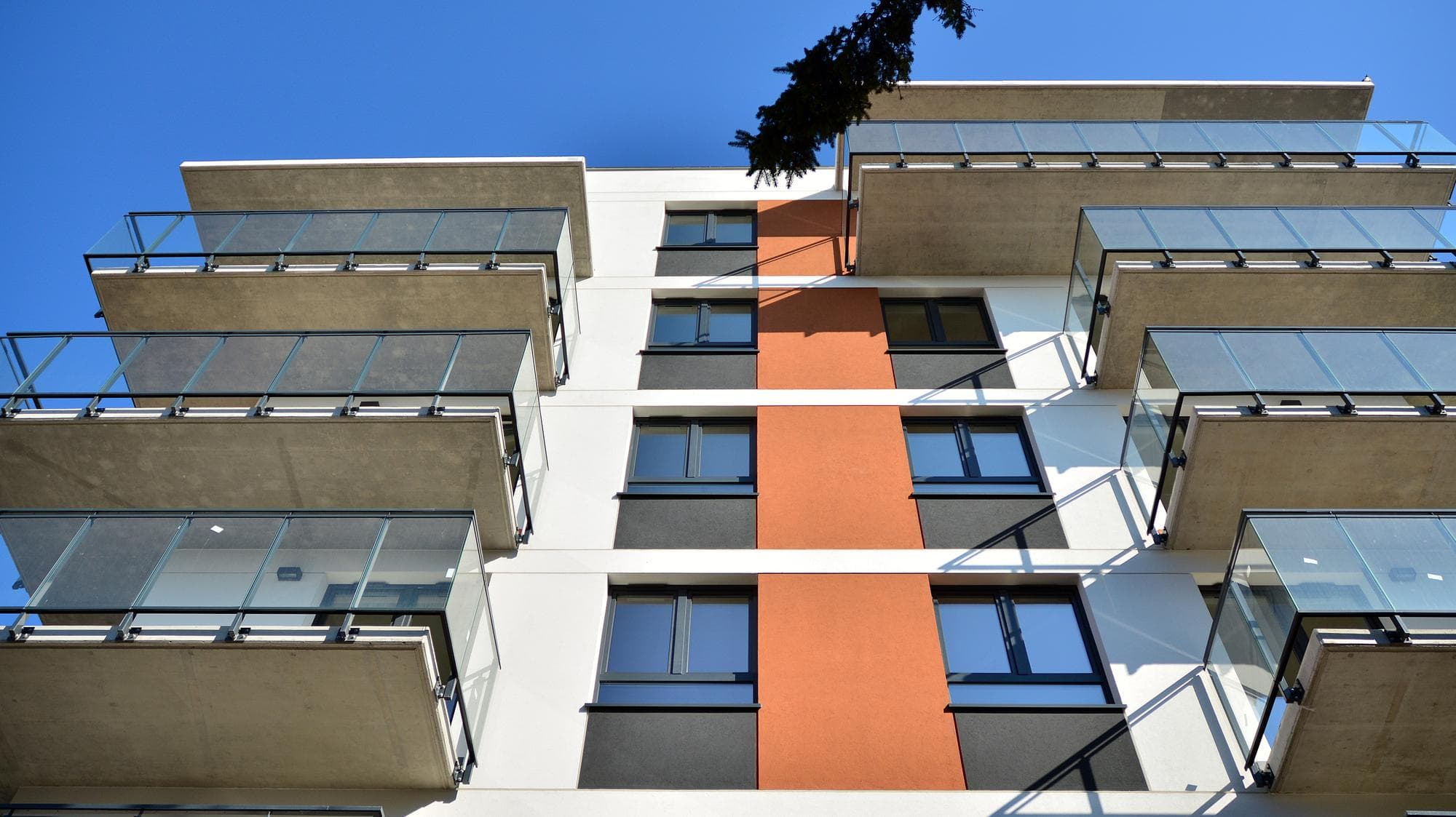 Modern apartment building facade with glass balconies